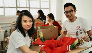 Hunger relief: A man and a woman packaging up food in boxes